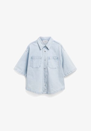 Light blue denim shirt with short sleeves, pointed collar, button front, and two chest pockets. Features a relaxed fit and slightly curved hem.