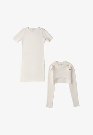 Abito corto a maniche corte in maglia a coste bianca e top a maniche lunghe corto, con dettagli in bottoni dorati sulla spalla del top.