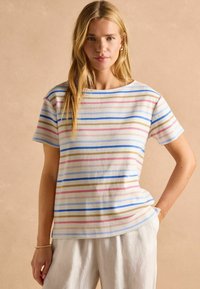 Cotton T-shirt featuring horizontal stripes in pink, blue, and brown on a white background, with a relaxed fit and round neckline.