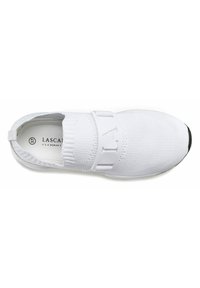 White athletic shoe with a knitted upper, wide white strap featuring the letter "L," and a black rubber tip. Soft, flexible design.