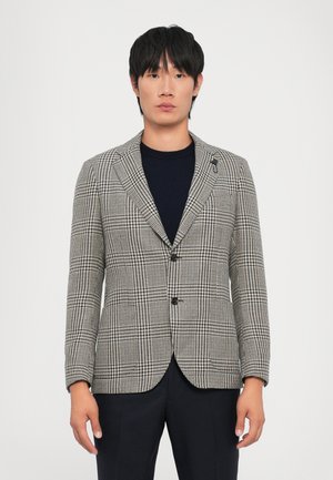 Checked blazer in black and white, tailored fit, single breasted with two buttons, notch lapel, and subtle pattern texture.