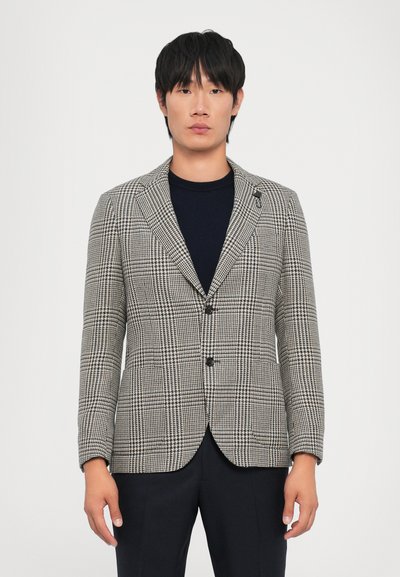 Checked blazer in black and white, tailored fit, single breasted with two buttons, notch lapel, and subtle pattern texture.