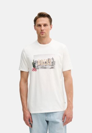 Camiseta de algodón blanca con un estampado gráfico de cactus y flores con "GUESS" en letras grandes. Mangas de corte recto y cuello redondo.
