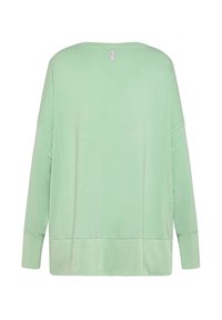 Vihreän sävyinen, pitkähihainen, pyöreäkauluksinen paita, valmistettu pehmeästä kankaasta ja rento istuvuus. Ominaisuuksiin kuuluu tikkaukset helmassa ja takakauluksessa oleva merkki.