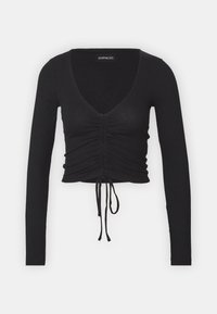 Black ribbed long-sleeve crop top featuring a deep V-neck, gathered detailing at the front, and adjustable tie at the hem.