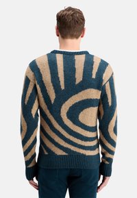 Knit sweater featuring a teal and tan swirl pattern, round neck, and ribbed cuffs and hem. Textured fabric with a soft finish.