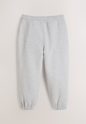 Pelēkas sporta bikses no mīksta auduma ar elastīgu vidukli un elastīgām aprocēm pie potītēm. Gluda tekstūra bez rakstiem.