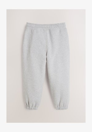 Šedé tepláky z měkké látky, s elastickým pasem a elastickými manžetami na kotnících. Hladká textura bez vzorů.