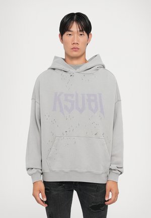 Gray hoodie with KSUBI logo in purple. Features distressed detailing and a front pocket. Cotton material with a soft texture.