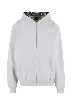 Hellgraue Zip-Hoodie mit Fronttaschen, gerippten Bündchen und einem gemusterten schwarz-weißen Innenfutter der Kapuze.