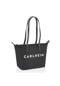 Czarna torba typu tote o wyraźnej, usztywnionej konstrukcji, z dwoma długimi uchwytami i zamkiem błyskawicznym u góry. Na przedniej stronie znajduje się biały napis „CARLHEIM.”