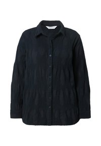 Camicia nera con un motivo tessuto, dotata di una chiusura con bottoni, maniche lunghe e colletto classico. Vestibilità leggermente ampia.