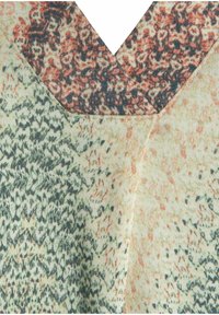 Knit top featuring a V-neckline, with a textured pattern in green, orange, and beige hues. Soft fabric with intricate detailing on the neckline.