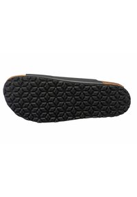 Black rubber shoe sole featuring a hexagonal tread pattern and a cork accent along the edge. The design offers traction and durability.