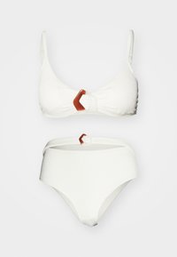 White bikini set with textured fabric; triangular bra features a brown and white geometric accent. High-waisted bottom with similar detail.