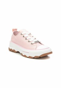 Zapatillas de lona rosas con cordones blancos, puntera de goma y una gruesa suela intermedia blanca con una suela externa de color marrón texturizado.