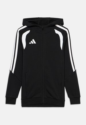Hanorac negru cu fermoar, cu dungi albe pe mâneci, accente albe lângă umeri și un logo Adidas alb pe piept.