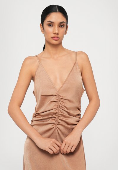 Ruched midi dress in a blush color, featuring thin straps, a deep V-neckline, and a textured fabric with subtle sheen.