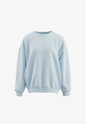 Jasnoniebieska oversize bluza z długimi rękawami, ściągaczami na mankietach i u dołu, z okrągłym dekoltem ozdobionym szwem w kształcie litery V.