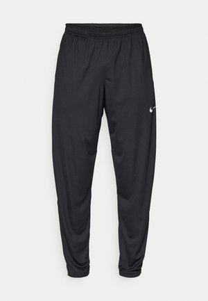 Mustat urheiluhousut, joissa on joustava vyötärö, kapenevat lahkeet ja pieni valkoinen Nike-logo vasemmassa reidessä. Tasainen kangas, ei kuvioita.