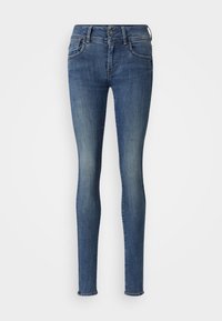 Jean skinny en denim bleu foncé, avec une fermeture à bouton et à zip, un design à cinq poches et une finition légèrement délavée au niveau des cuisses.