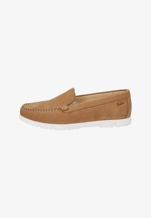 Tan suede loafers with a white rubber sole. Features a stitched seam and a discrete logo on the side. Slip-on design with a smooth texture.