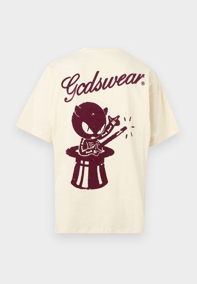 Cream-colored cotton t-shirt featuring a maroon graphic of a character playing guitar on a drum, with "Gadswear" text above.