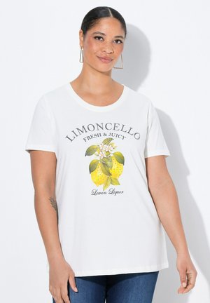 T-shirt en coton blanc avec un imprimé graphique de citrons et de fleurs, portant le texte "Limoncello Fresh & Juicy" en noir. Manches courtes.