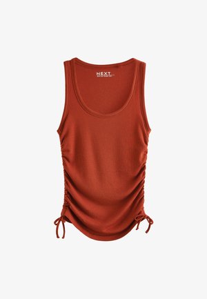 Top na ramiączkach w kolorze rdzy, wykonany z prążkowanej tkaniny, z regulowanym marszczeniem z boku za pomocą troczków. Okrągły dekolt i bez rękawów.
