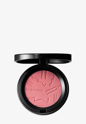 Boîtier noir compact avec couvercle ouvert révélant un blush rose pressé embossé de lettres stylisées "MAC" et de formes géométriques.