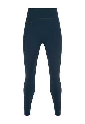 Temno modre legice iz raztegljivega, gladkega materiala; visok pas; majhen črn logotip na levi strani; oprijeta zasnova z zoženjem pri gležnjih.