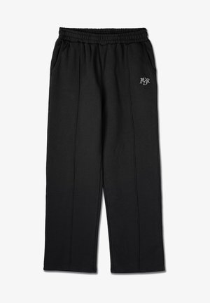 Čierne tepláky s elastickým pásom, bočnými vreckami a malým logom na ľavom stehne. Vyrobené z mäkkej, štruktúrovanej tkaniny.