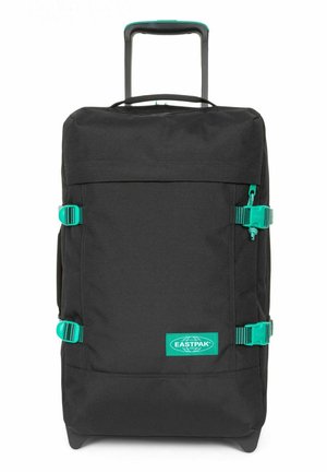 Black wheeled duffel bag with turquoise buckles and accents, made of durable fabric, featuring a retractable handle and label.