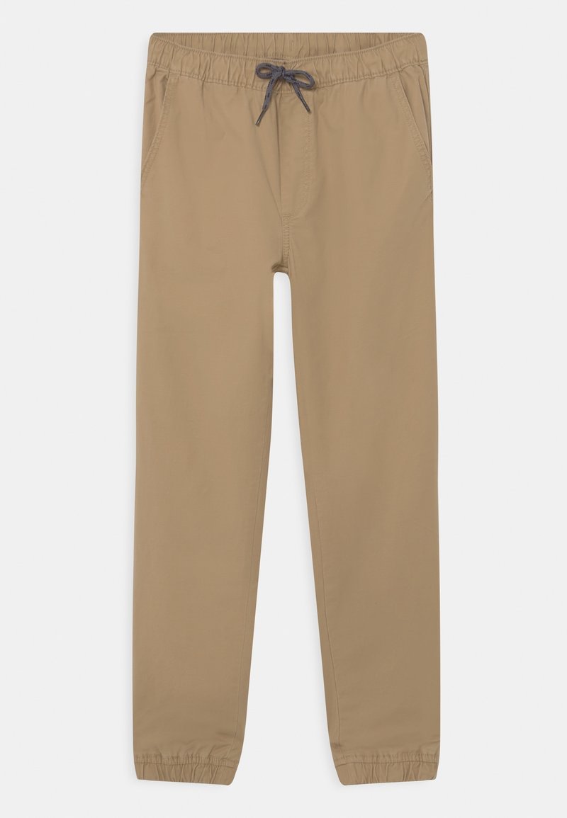 Pantalon beige à taille élastique avec cordon de serrage, poches latérales et poignets élastiques aux chevilles, posé à plat sur fond blanc.