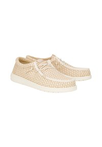 Sneakers in tessuto beige chiaro con accenti bianchi, punta arrotondata, suola piatta e design con lacci. Parte superiore texturizzata per la traspirabilità.
