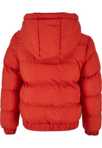 Rød puffjakke med hette, med kviltet design, elastiske ermer og samlet hem for isolasjon og komfort.