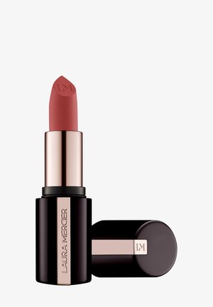 Lippenstift in runder Bullet-Form, dunkelbrauner Fall mit Chrom-Akzenten und eingraviertem Logo. Die Farbe ist ein sanftes, gedämpftes Pink mit matter Oberfläche.