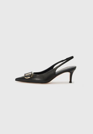 Black leather slingback pump with pointed toe, gold buckle detail, slender heel, and smooth texture. Minimalist design for easy pairing.