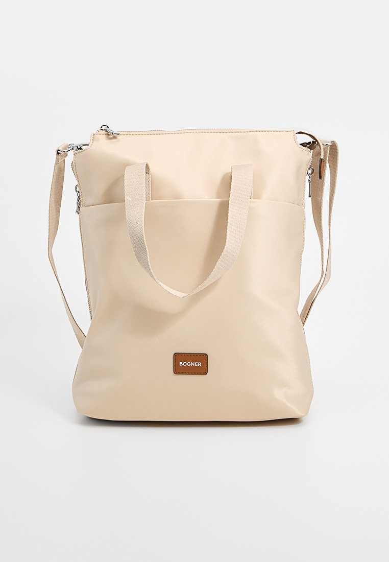 Beige synthetische Tragetasche mit doppelten Griffen und abnehmbarem Schultergurt. Mit einem Reißverschluss und einem braunen Logo-Patch auf der Vorderseite.