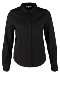 Chemise noire à manches longues avec col pointu et silhouette ajustée.