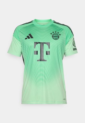 Maillot de football vert menthe avec des accents noirs, design dégradé, présentant un grand logo noir au centre et un emblème d'équipe en haut à gauche.