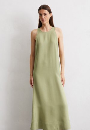 Sleek, sleeveless maxi dress in light green fabric. Features a round neckline, side pockets, and a smooth, matte texture.