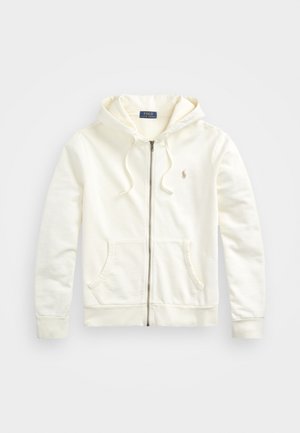 Hvid zip-up hoodie med snoretræk i hætten, frontlommer, ribbede manchetter og et lille broderet logo på venstre side. Blødt bomuldsstof.