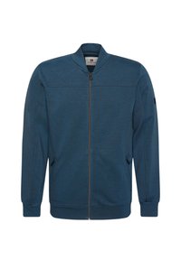 Veste bleue à fermeture éclair intégrale avec col montant, manches longues, poignets et ourlet côtelés, et poches latérales zippées.