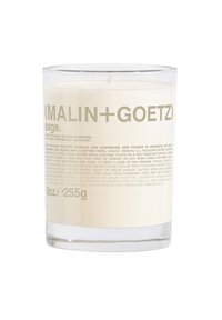 Klarer Glaskerzenbehälter gefüllt mit weißem Wachs. Hellgrauer Text enthält Marken- und Produktinformationen. Baumwolldocht, 9 oz Volumen.