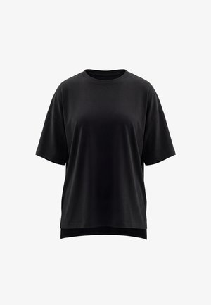 T-shirt oversize nera tinta unita con maniche corte, scollo rotondo e orlo posteriore leggermente più lungo.