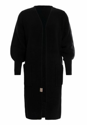 Un long cardigan noir en tricot ouvert à l'avant avec des manches ballons et deux poches avant, fabriqué en tissu texturé.