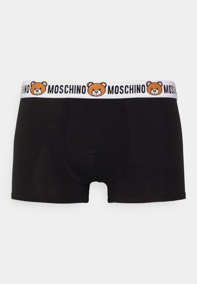 Melnas bokseršortus ar baltu jostasvietu, kurā ir izšūts lāča dizains un vārds "Moschino". Gluda auduma, pieguloša forma.