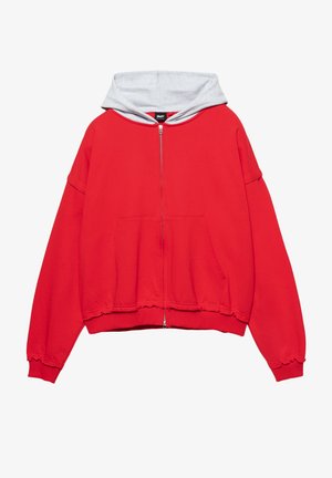 Felpa con zip rossa con cappuccio foderato in grigio, design oversize, grande tasca frontale e orlo e polsini a costine. Tessuto morbido.