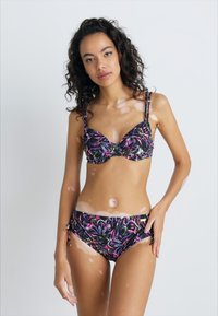 Black bikini with a floral pattern in pink and green hues; features adjustable straps and a decorative twist at the center.